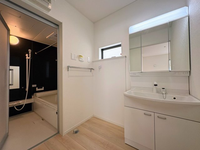 クレイドルガーデン南城市大里稲嶺 第4・１号棟の独立洗面台|ハンドシャワー付き洗面化粧台＆洗濯機置き場から浴室への動線