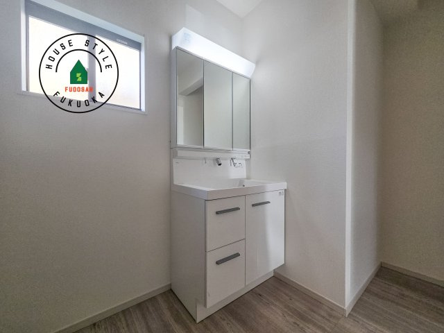 福岡市南区皿山4丁目第3-2棟（1号棟）の内観：施工例|毎日使うものだから清潔な空間を保ちたい水回り。洗面にはそんな願いを解消させてくれる収納アイデアが満載です。三面鏡の裏側にはキャビネットが現れ小物から背の高い物まで収納できます。