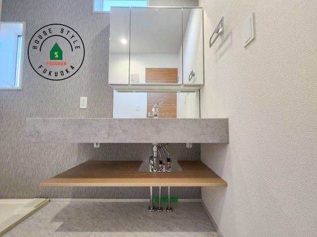 福岡市早良区飯倉3丁目第1-2棟(2号棟)の独立洗面台|毎日使うものだから清潔な空間を保ちたい水回り。洗面にはそんな願いを解消させてくれる収納アイデアが満載です。三面鏡の裏側にはキャビネットが現れ小物から背の高い物まで収納できます。