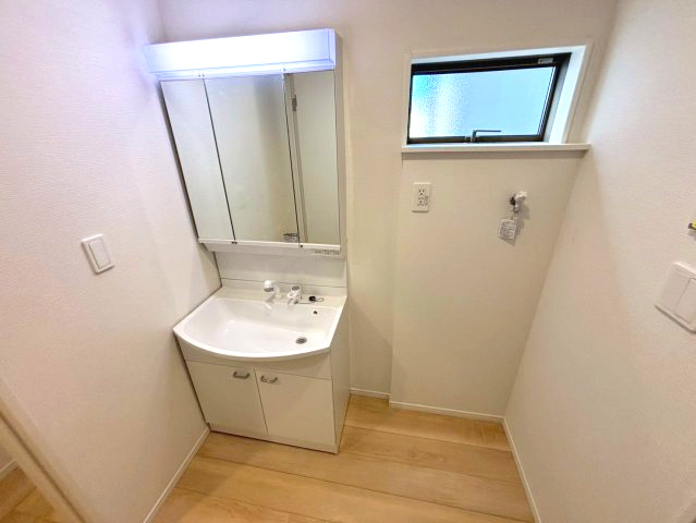 永吉2丁目　新築戸建ての洗面所|三面鏡洗面化粧台採用の洗面脱衣所。シャワー付きなのでお手入れもラクラクです。