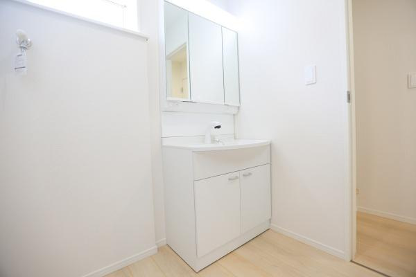 寒田北町第1-1号棟の独立洗面台|清潔感のある洗面所が特徴です。収納スペースも豊富で使い勝手が良いです。広々とした空間で毎日の準備がスムーズに行えます。ナチュラルカラーの床材が明るさを演出しています。