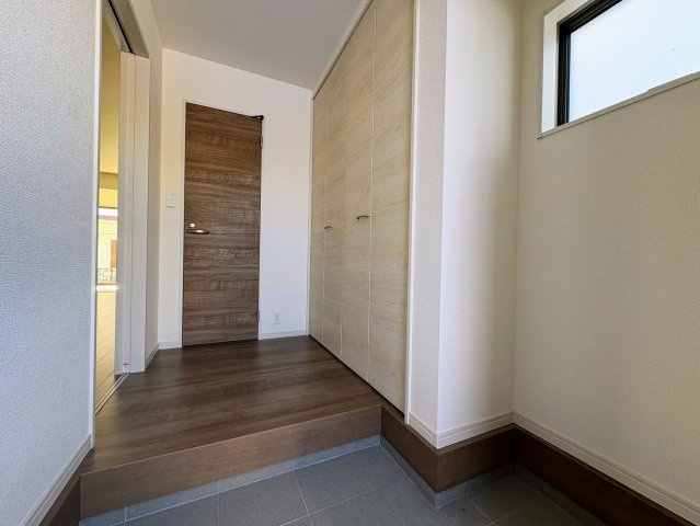 リーブルガーデン沖縄市南桃原・３号棟の玄関|上がり框からリビングへ続く玄関ホール／シューズクローゼット付き