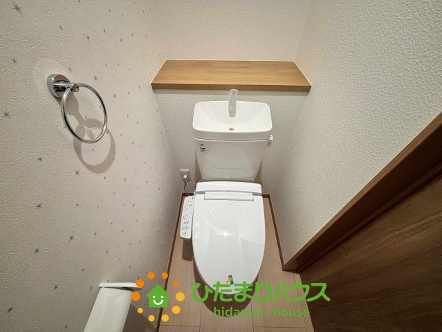 ワイウッドコート加須市多門寺第11期　新築一戸建て　02のトイレ|清潔感あふれる温水洗浄便座付きのトイレです！手洗い付きのタンクは節水にも繋がり経済的。背面のカウンターにはお好みの雑貨を飾ったり、予備のペーパーを置いたりと便利に使えます。星柄の壁紙が可愛いですね♪