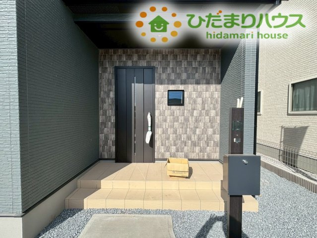 滑川町月の輪　第2期　新築一戸建て　ワイウッドコート　05のエントランス|深い軒が雨や直射日光を遮ってくれる、インナーポーチ仕様の安心感あるエントランスです！モダンな色調の玄関ドアが上品な印象を与え、階段が少ないアプローチなのでベビーカーでの出入りもスムーズです◎