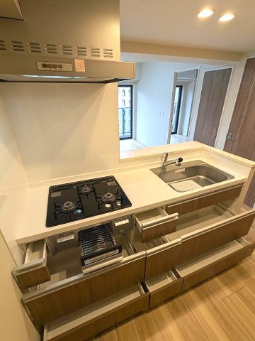 URBAN PARK浅草Ⅱの設備|グリル付ガス3口システムカウンターキッチン、瀟洒でお手入れ楽なガラストップコンロ、ビルトイン浄水器、ワイドシンク、奥の物の出し入れし易いスライド収納です
