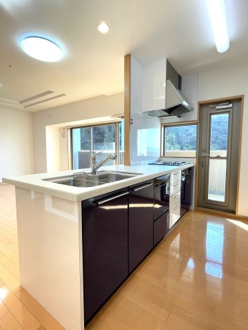 ヴィラージュ海田「緑彩の街」のキッチン|浄水器付水栓、食洗器、3口ガスコンロで機能的なキッチン。換気面にもよいバルコニーへの勝手口があります