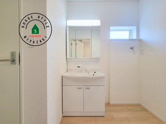 宮崎市大塚町第13-1棟（1号棟）の内観：施工例|毎日使うものだから清潔な空間を保ちたい水回り。洗面にはそんな願いを解消させてくれる収納アイデアが満載です。三面鏡の裏側にはキャビネットが現れ小物から背の高い物まで収納できます。