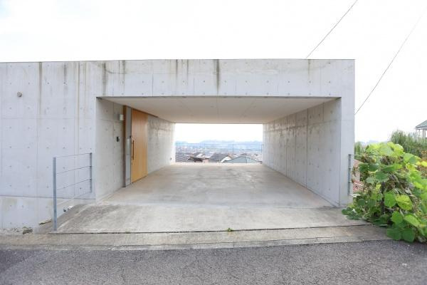 青葉台　戸建ての玄関|コンクリート打ちっぱなしのシンプルなデザインが特徴的です。開放感ある玄関スペースで印象的な外観となっています。道路からのアプローチもスムーズです。視界の抜けが心地よい雰囲気を醸し出しています。