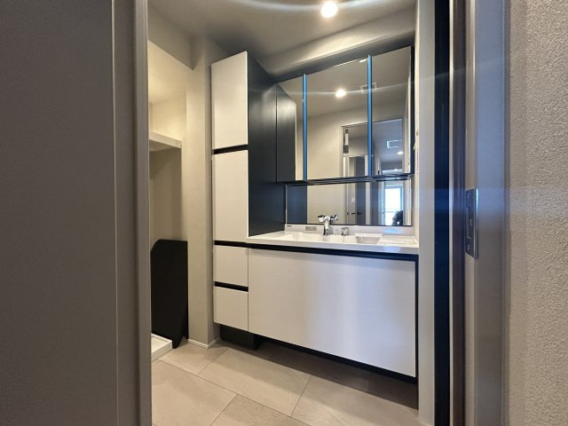 リーデンスタワーの独立洗面台|～Powder room～
横幅のある広々とした洗面化粧台を採用し、キャビネット収納はぎっしり色々な物を収納でき下部収納もございます。