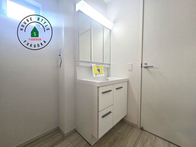 福岡市東区千早1丁目第2-2棟(2号棟)の内観：施工例|毎日使うものだから清潔な空間を保ちたい水回り。洗面にはそんな願いを解消させてくれる収納アイデアが満載です。三面鏡の裏側にはキャビネットが現れ小物から背の高い物まで収納できます。