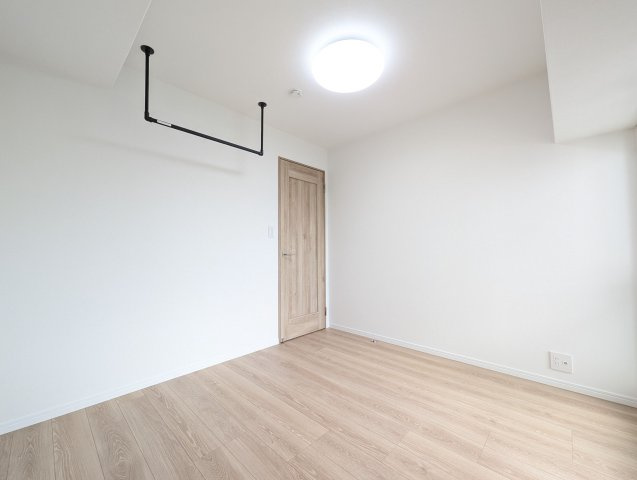 【洋室】 | 日商岩井リバーサイドマンションA棟 | 室内物干しも設けられているのでお洋服をかけて置いたり、ご家族の人数によっては家事部屋にもできそうです