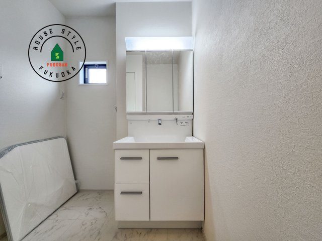 福岡市西区小戸3丁目第4-3棟(2号棟)の独立洗面台|毎日使うものだから清潔な空間を保ちたい水回り。洗面にはそんな願いを解消させてくれる収納アイデアが満載です。三面鏡の裏側にはキャビネットが現れ小物から背の高い物まで収納できます。