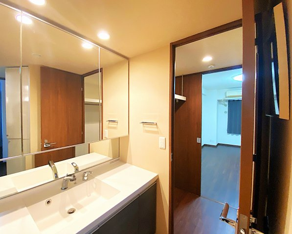 レーヴェンリゾシアヴェスティブルーの独立洗面台|ウォークスルークローゼットの奥に洋逸が見える