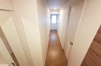 【内装】 | シティパーク北野田 | 玄関から各部屋へ繋がる廊下。木のぬくもりと白を基調とした明るい空間。LDKのドアからやわらかな光が差し込みます。