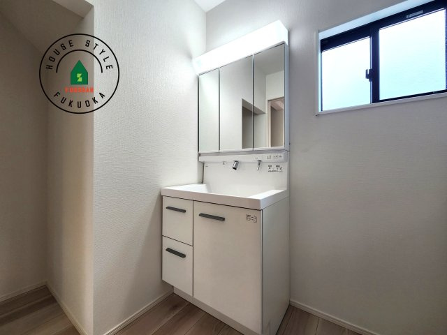 福岡市早良区重留2丁目第2-2棟(2号棟)の内観：施工例|毎日使うものだから清潔な空間を保ちたい水回り。洗面にはそんな願いを解消させてくれる収納アイデアが満載です。三面鏡の裏側にはキャビネットが現れ小物から背の高い物まで収納できます。