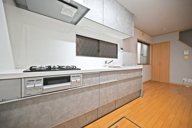 伊丹市東野4丁目中古戸建│4LDK+駐車1台可のキッチン|1階キッチンの内観写真です。食洗機が搭載されたシステムキッチン◎3口コンロでお料理の幅が広がります。 上下に収納があり収納豊富なため、常にすっきり保つことが出来ます。