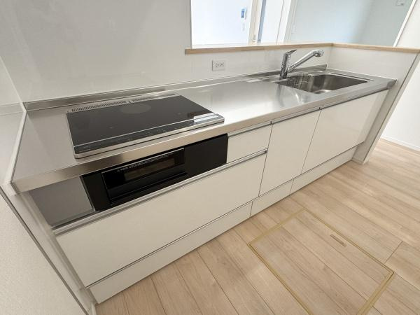 徳島第7-1号棟のキッチン|シンプルで洗練されたデザインのキッチンです。広い作業スペースが確保されており使い勝手の良さが魅力です。明るい内装と調和した空間で収納も豊富に設けられています。