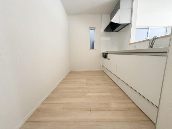 徳島第7-1号棟のキッチン|シンプルで清潔感のあるキッチンです。床材の色合いが爽やかさを演出しています。窓からの自然光も心地よく入ります。調理スペースも広く作業がしやすそうです。