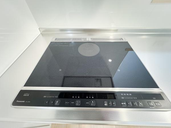 畑中第1-2号棟のキッチン|フラットなIHクッキングヒーターでお手入れが簡単です。シンプルな操作パネルが使い勝手を高めています。スタイリッシュなデザインでキッチンの印象を引き締めます。調理スペースも十分に確保されています。