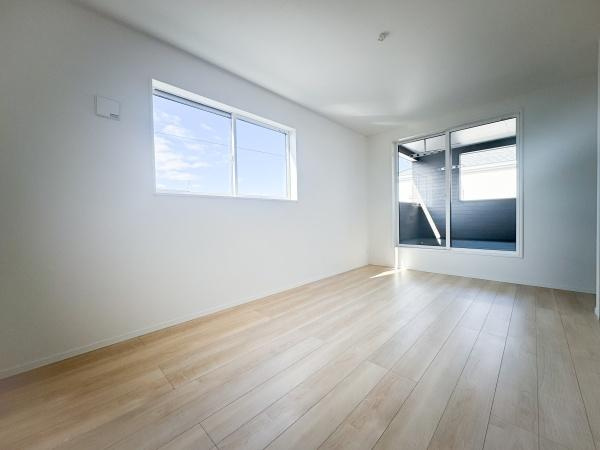 畑中第1-2号棟の洋室|明るい窓からの自然光が印象的な洋室です。ナチュラルなフローリングで落ち着いた雰囲気が広がります。シンプルな内装が空間の広がりを感じさせます。使い勝手の良い形状で多目的に活用できます。
