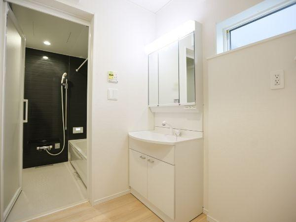 横田第2-2号棟の独立洗面台|洗面台・洗面所は清潔感のあるホワイトカラーで統一されています。収納スペースも豊富で整理整頓がしやすい設計です。隣接する浴室とスムーズに行き来できるのも便利です。採光窓があり明るい空間となっています。