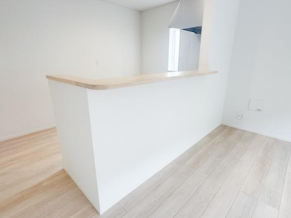 徳島第6-1号棟の居間・リビング|白を基調としたリビングがすっきりとした印象です。カウンターが空間のアクセントになっています。フローリングの色合いが明るく全体的に清潔感があります。オープンな雰囲気が感じられます。