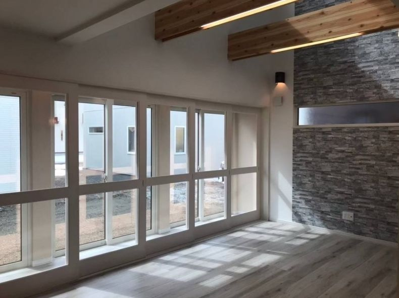 【文苑3丁目】築浅！広々駐車3台可！デザイン性と機能性を両立した4LDKの居間・リビング|木の梁と石調クロスが映える、明るく開放的なリビング。