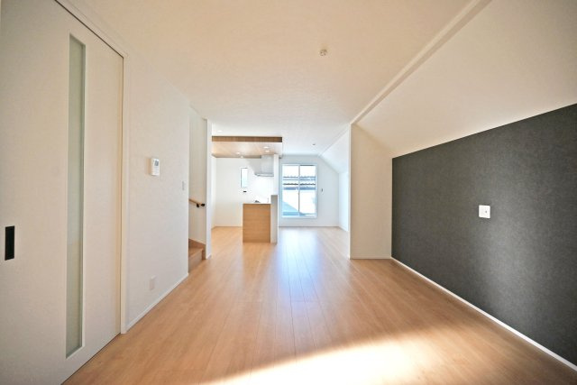 宝塚市高司1丁目新築一戸建て│3SLDK+並列駐車2台可(車種制限有)の居間・リビング|2階LDKをリビング側から正面に撮影した内観写真です。テレビボード側にはアクセントクロスを採用しており、インテリアが映える広々としたリビングは18.3帖の広さが確保されています。