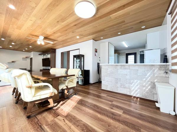 判田台南3丁目　戸建の居間・リビング|木目調の天井と床が統一感のある空間を演出しています。広々としたリビングは家具の配置が自在です。窓から自然光が入り明るい雰囲気が広がります。キッチンとのつながりも良好で動線がスムーズです。