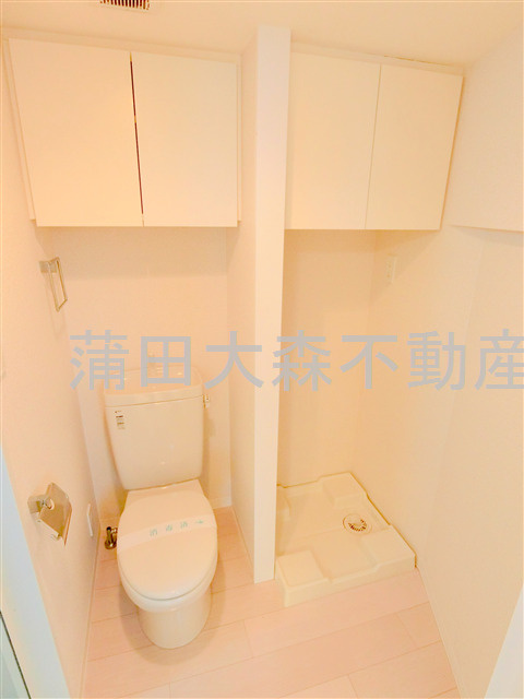 ビバリーホームズ久が原Ⅱのトイレ|棚収納付のトイレと洗濯機置き場