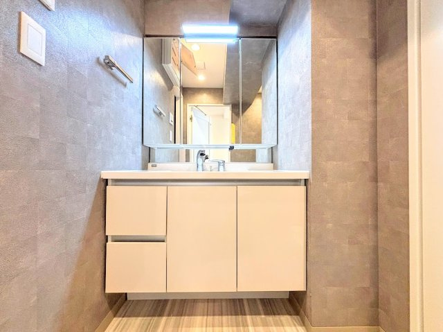 コスモ戸塚パークスクエアの独立洗面台|◆三面鏡裏や、シンクしたにも多数収納を備えた、広々とした洗面化粧台。窓のある明るい洗面所で毎日の身支度も気持ち良くお使い頂けます。