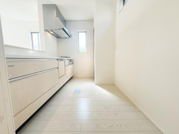 小中島3丁目1期1号棟のキッチン|ガスコンロが三口設置されており同時に複数の調理がしやすい仕様です。天板はフラットでお手入れしやすい印象です。広々としたスペースで作業もスムーズに進められます。