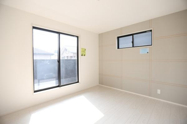 横尾東町1丁目1期2号棟の洋室|大きな窓から自然光が差し込む明るい洋室です。シンプルで使い勝手の良い内装が特長です。壁面のアクセントが落ち着いた雰囲気を与えます。