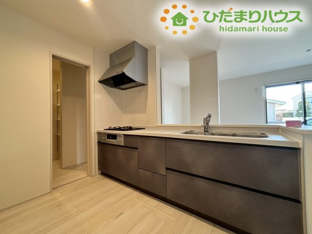 熊谷市万平町　第3　新築一戸建て　リーブルガーデン　02のキッチン|シックなダークトーンの面材がお洒落な、最新のシステムキッチンです！広々としたシンクやワークトップが採用されており、毎日のご飯作りが手際よく楽しめます。収納スペースも充実しています！