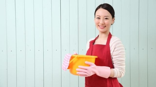 生ごみの臭いを抑えるための対策を行っている女性の写真